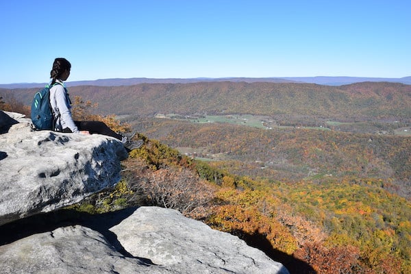 Hiker sitting on overlook traveling alone