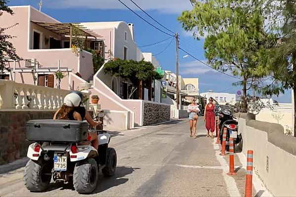 4 Wheel ATV riders and pedestrians in Akrotiri Santorini