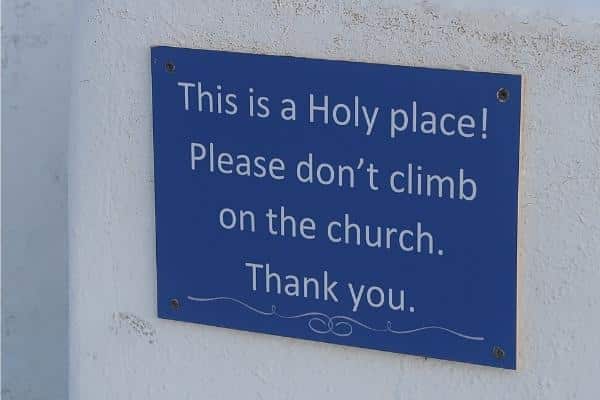 Don't stand on church sign Oia Santorini