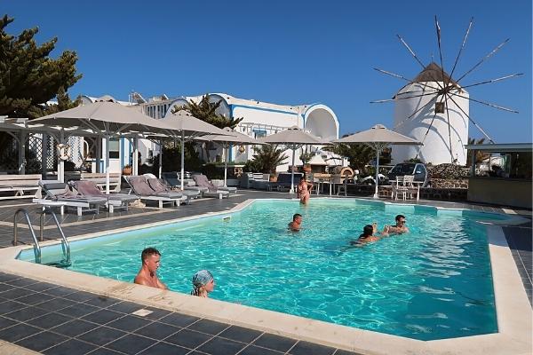 People in Milos Villas Hotel pool Santorini Greece