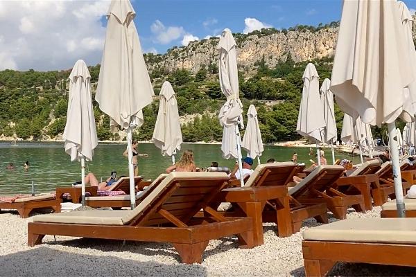 Sunbathers and lounge chairs on beach Split Croatia