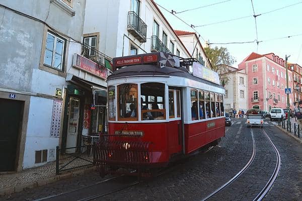 Lisbon red tram going downhill Alfama District Lisbon