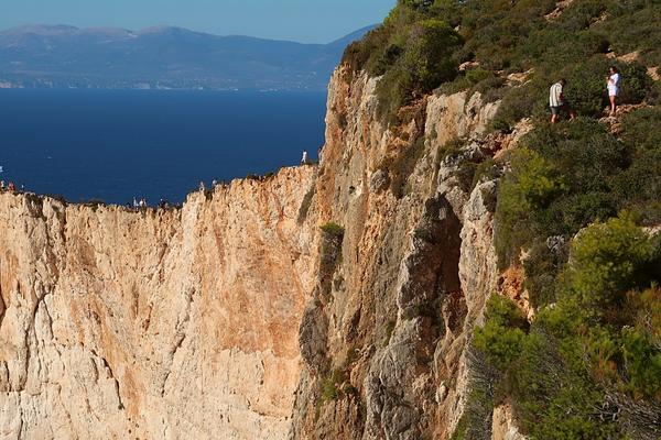 Stupid tourists on edge of cliffs Shipwreck View Point Zakynthos