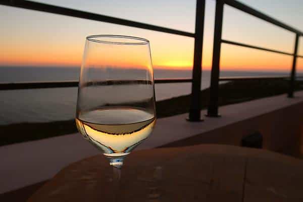 glass of white wine lete sunset bar patio at sunset Zakynthos