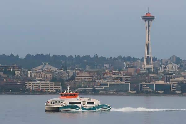 Ferry on water and Seattle Space Needle Washington