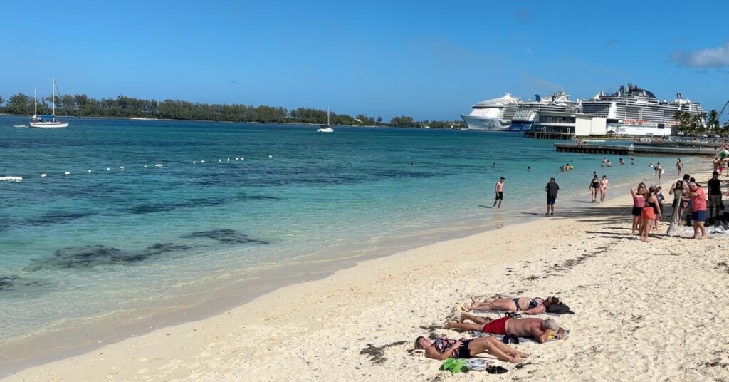People sunbathing on beach in Nassau Bahamas