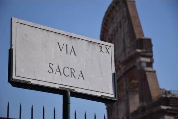 Via Sacra sign and Colosseum Rome Italy
